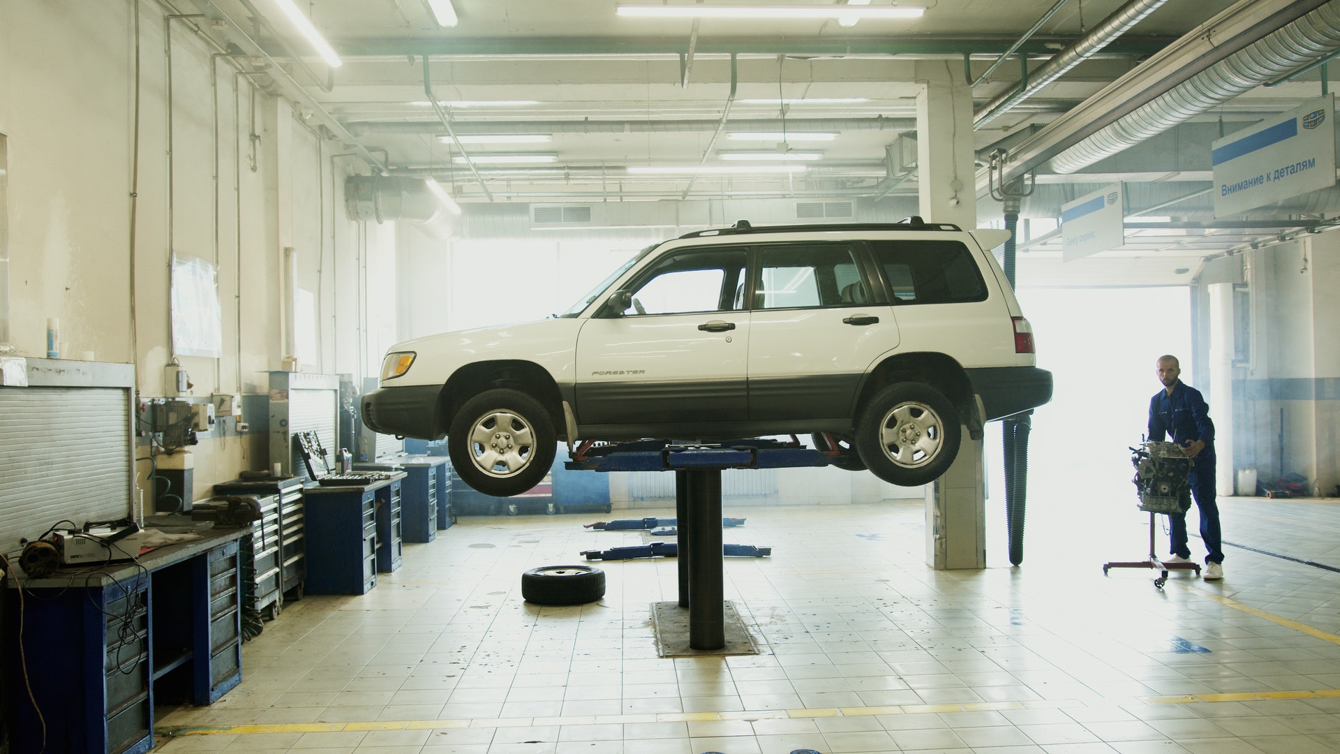 car being repaired in auto shop with car insurance