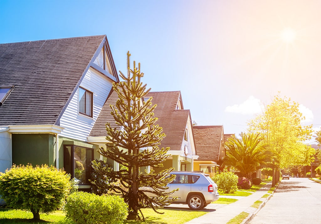 home with a car out front covered by home and auto insurance