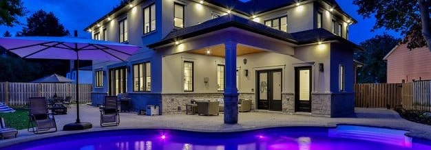 Nice house with pool at nighttime - Personal Umbrella Insurance