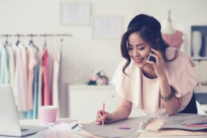 Woman business owner taking phone call - Business Owner's Insurance Policy